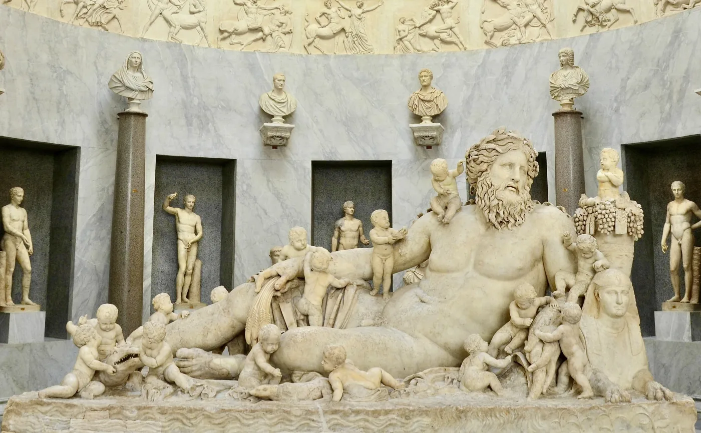From Rome's Temple of Isis and Serapis, the statue of Nilus, the river god of Egypt's Nile, features symbols like the cornucopia, wheatsheaf, sphinx, and crocodile, blending Egyptian and Roman motifs.